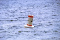 Lone buoy floating in the water close up