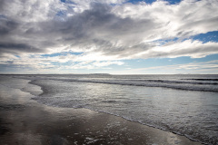 Peaceful waves and cloudy skies on the coastline (Old Orchard Beach, ME)